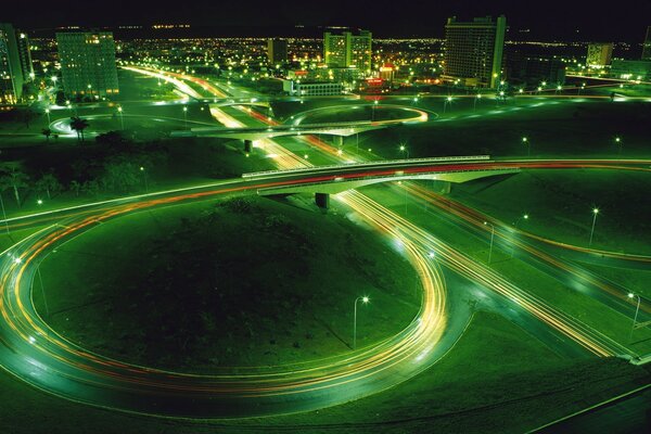 Turn of the night road on the background of green lights