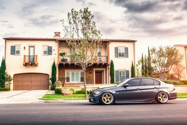 A car parked on the street near the house