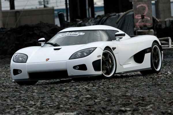 A white car parked on the shingle