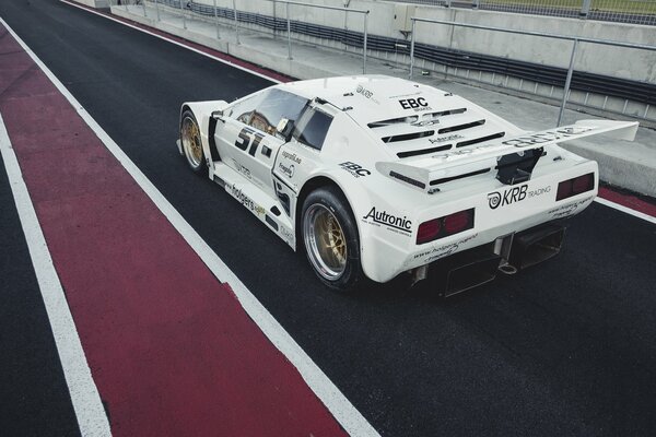 A sports car on the track. Possible wing