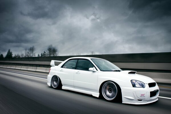 Fast white subaru impreza