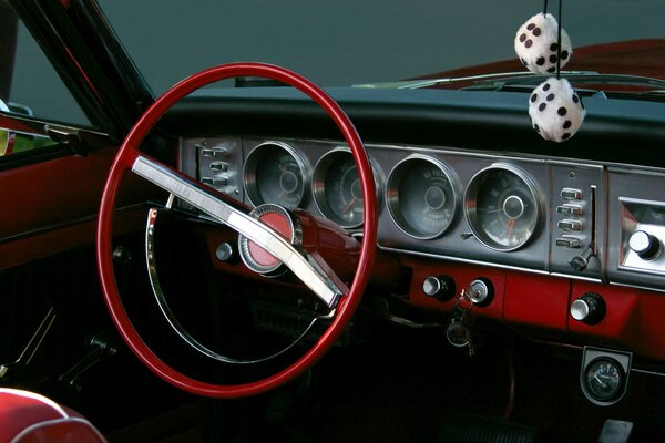 A keychain in the form of playing cubes hangs in the car interior