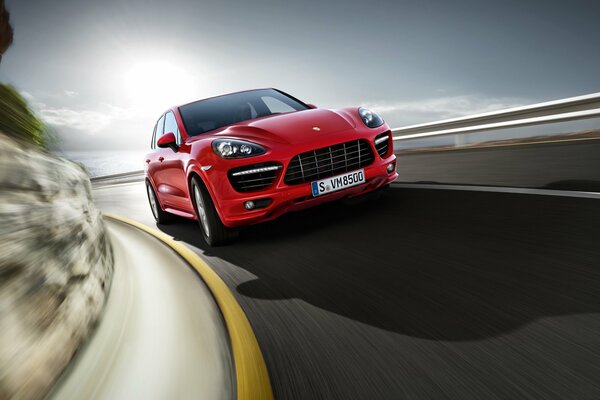 A red Porsche car on a road background