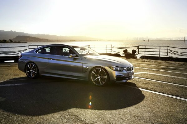 A silver car is parked at the pier