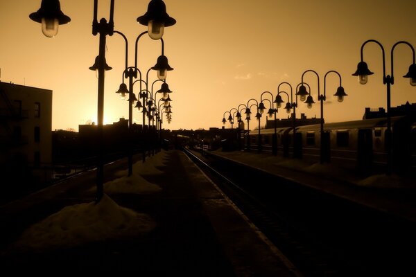 Lanternes Vintage le long du chemin de fer au coucher du soleil