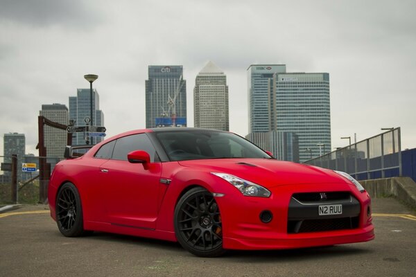 Nissan car on the background of city houses