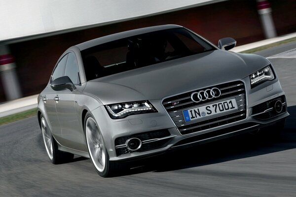 Grey audi s7 drives fast on the highway