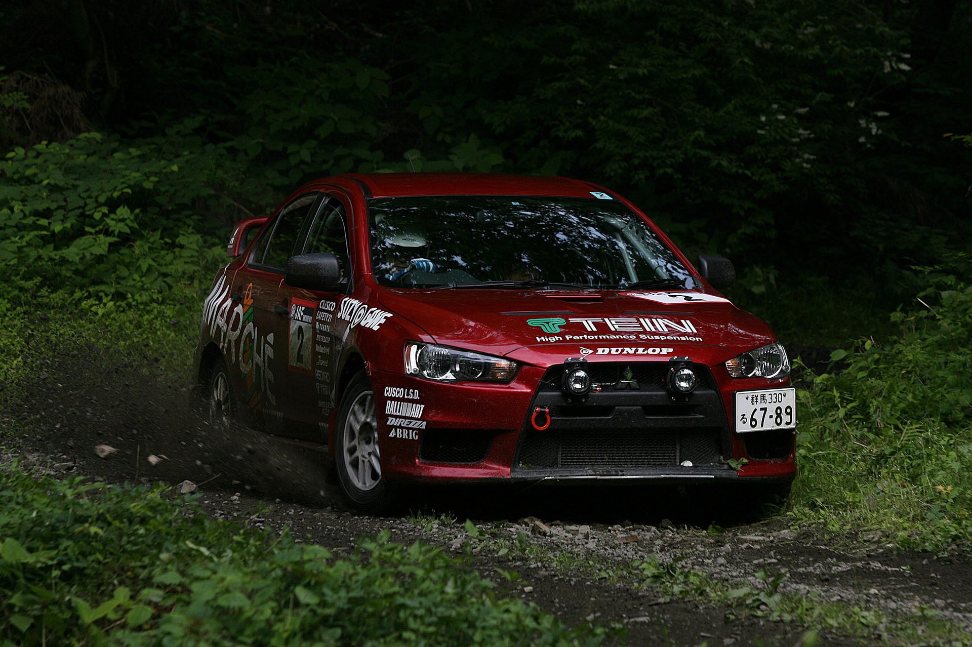 lancer x car rally mitsubishi auto red car inscriptions mitsubishi forest thickets greenery passenger cars cars transport motor transport