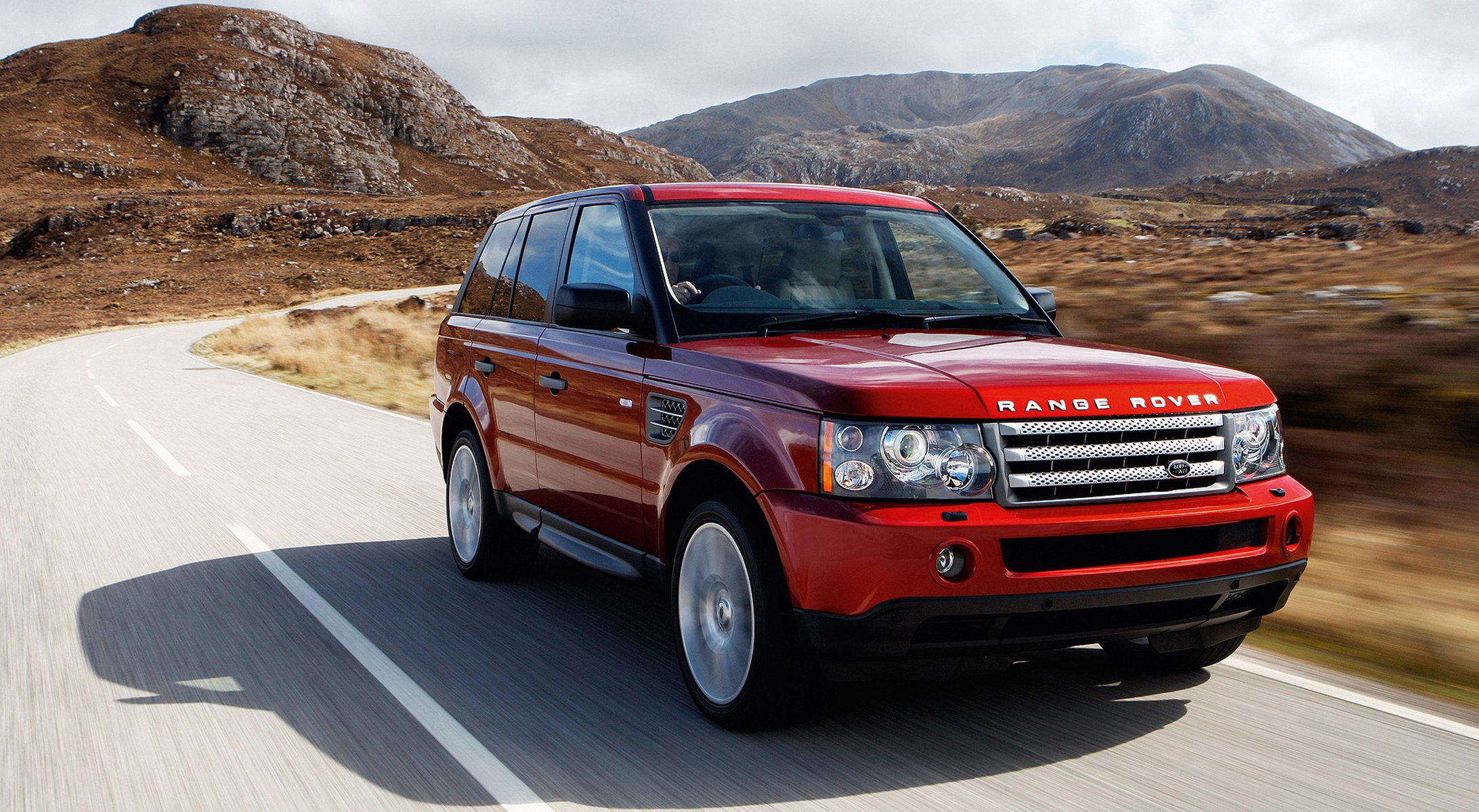 czerwony góry land rover samochód auto czerwone auto teren górski oznakowanie droga skręt prędkość ruch samochody osobowe transport motoryzacja