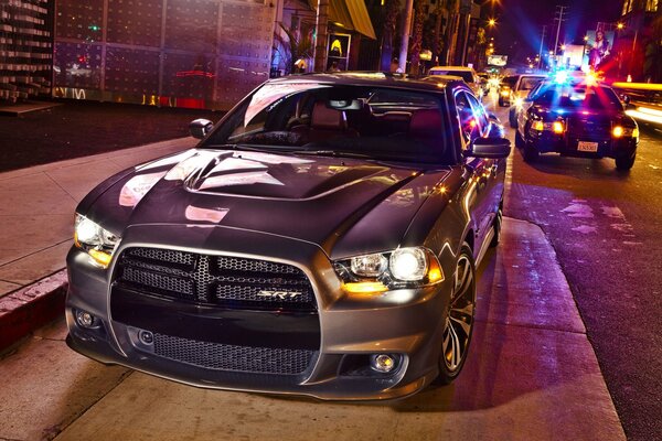 Silver car on night city roads