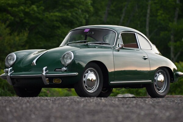 Retro Porsche green car in the forest