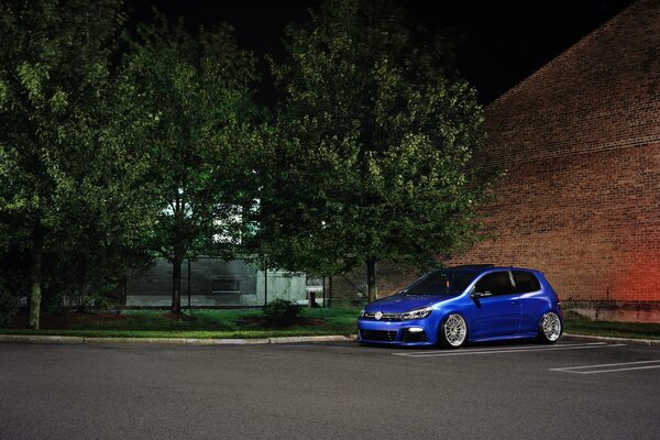 Une voiture de couleur bleue est stationnée