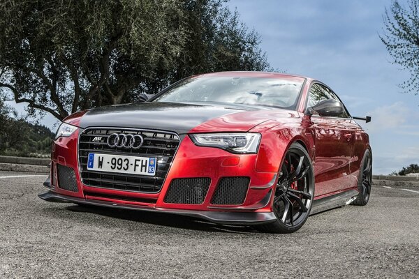 Tuned red and black audi rs5 on the road