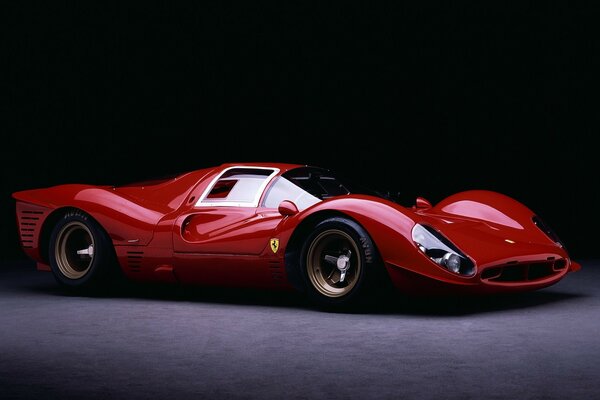 Red ferrari sports car on dark background