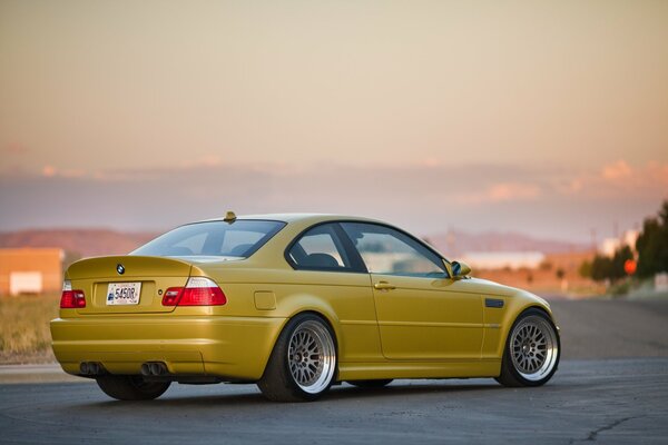 BMW e46 gold with tuning in the open, evening sky