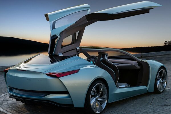 A sea-green car with open doors