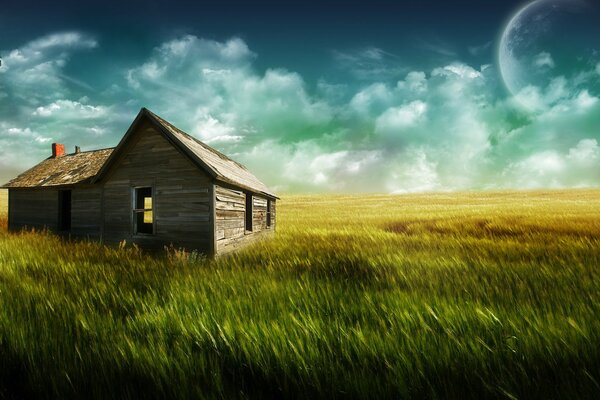 A mill and a wooden house in a field against the background of clouds