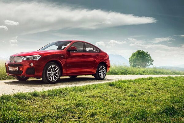 Red bmw x4 xdrive35i sports package m on the road