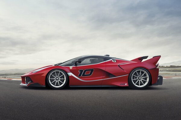 A red Ferrari supercar on the racing lane