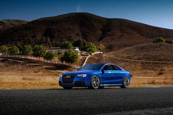 Auto sportiva audi rs5 colore blu a strada