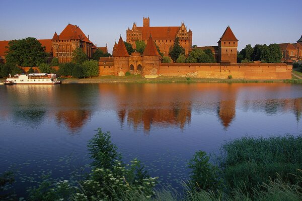 Mysterious reflection of trees and castle in the water