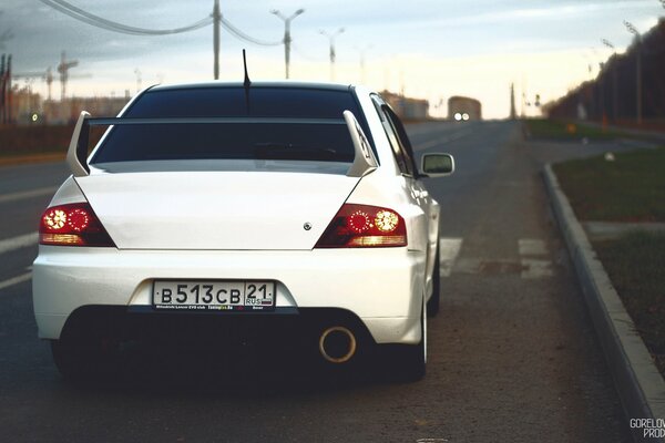 White Mitsubishi on a city road