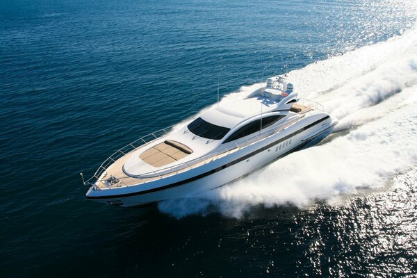 Yacht with sea foam on the background