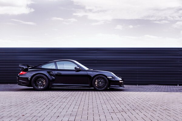 Side view of a black sports car in daylight