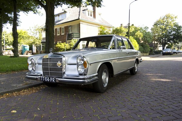 A rare Mercedes-Benz is parked at the curb