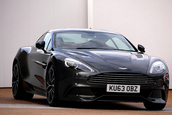 A chic tuned sports car on the background of a white wall