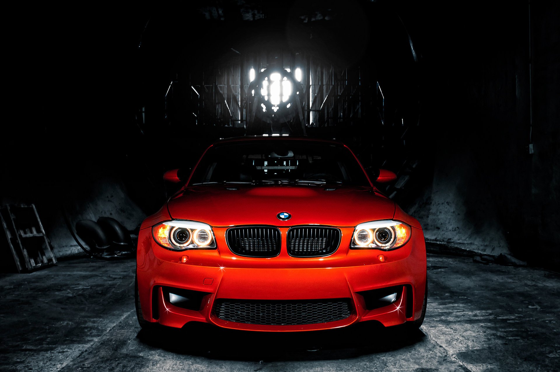 bmw 1m e82 bmw coupe sportcar czerwone tło reflektory optyka techno industrial samochody samochody auto samochód czerwone auto przed półmrok garaż koła opony bmw pojazd