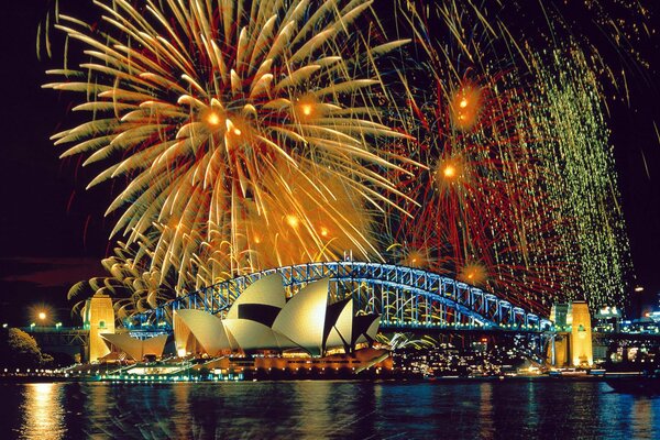 Fireworks over the bridge and its reflection in the river