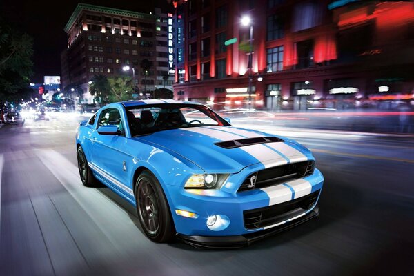 Blue car on the street at night