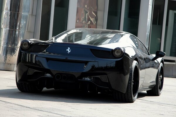 A black Ferrari car with a horse badge