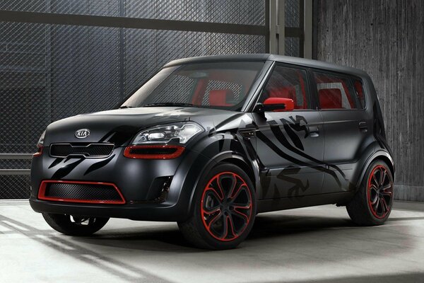 Black kia soul, with red elements