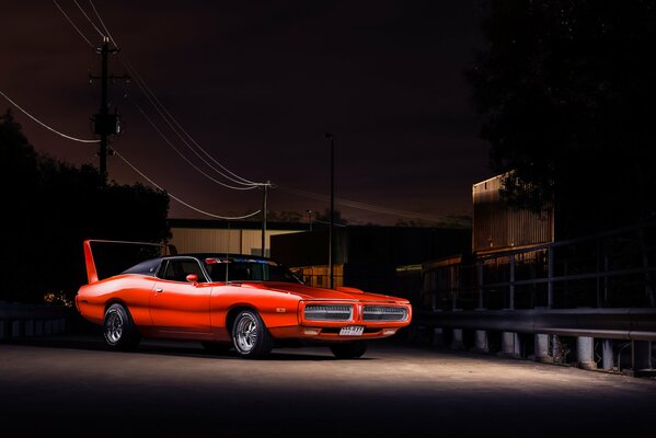 Red Dodge charger on a dark background