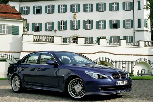 Blue BMW on the background of a beautiful building