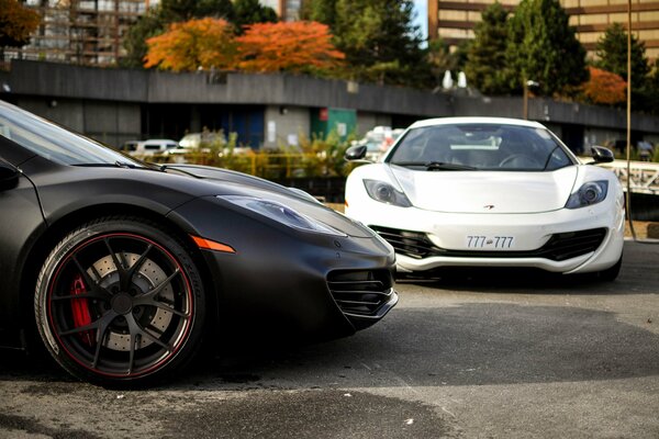 Two cars black and white in the city