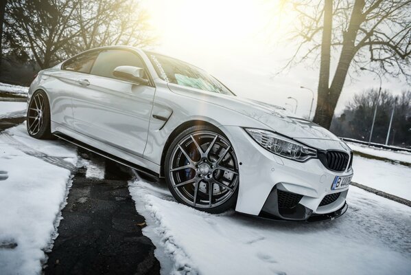 White BMW on a snowy road