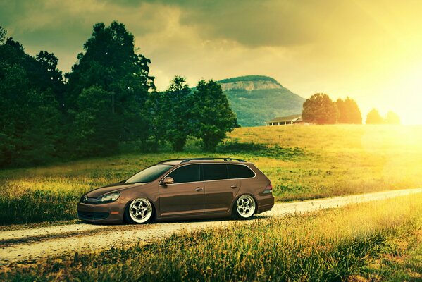 The golf car is on a dirt road in the field