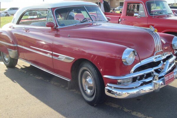 Red vintage car with white roof