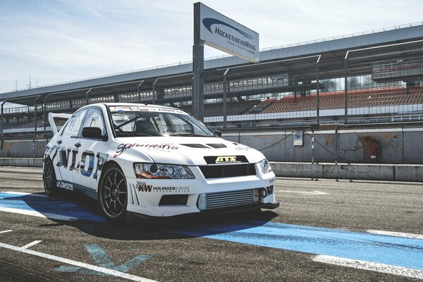 White racing Mitsubishi Lancer evolution on the track