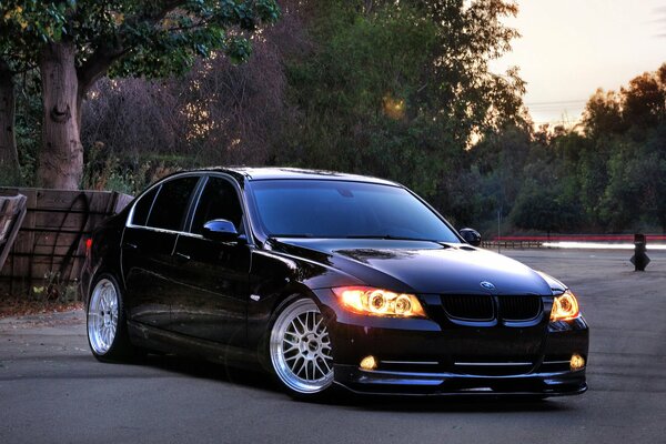 Cool BMW car in the evening with the headlights on