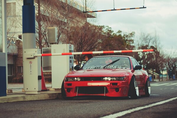 Red Nissan Sylvia behind the barrier