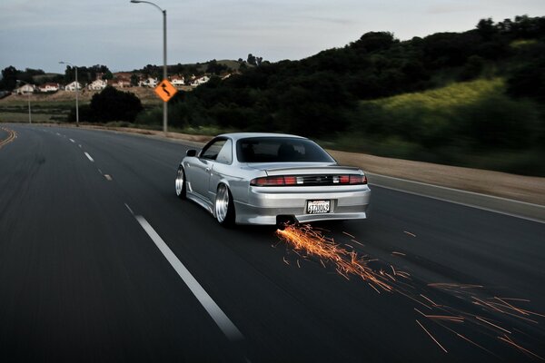 The car strikes sparks on a wide road