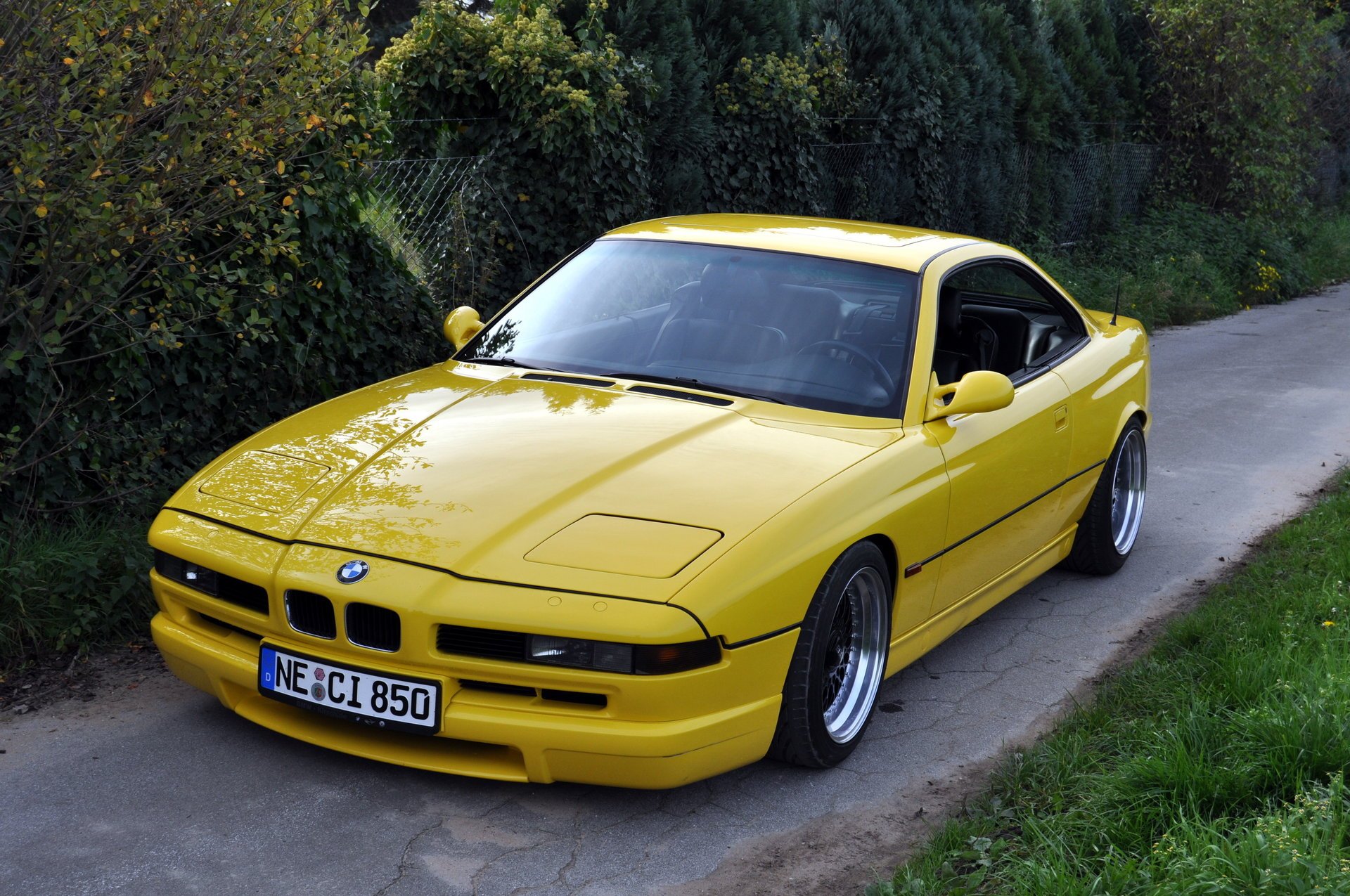 bmw 850 e31 bmw bmw coupe sports car yellow style design high-tech techno germany bavaria auto yellow car car car transport grass hedge greenery foliage passenger cars motor transport