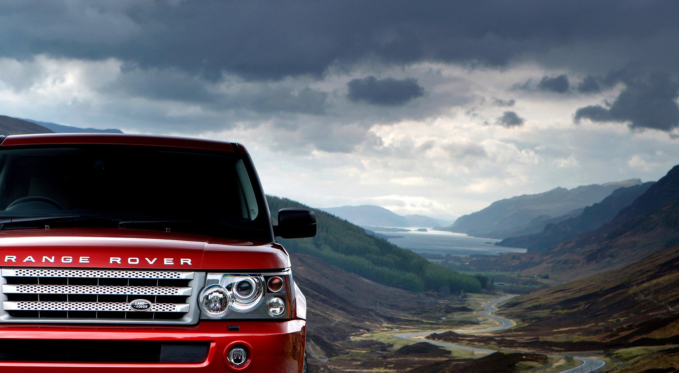 red mountain terrain clouds mountains range rover sport land rover sky forest lowland road landscape red car car auto car headlights transport clouds motor transport