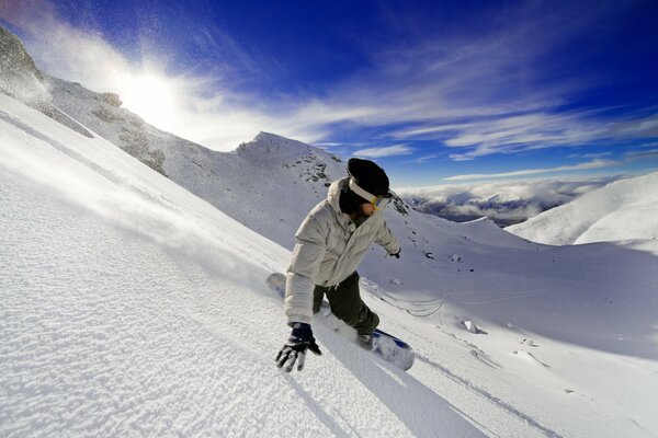 Guy goes snowboarding down the mountain