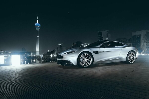 Aston Martin supprcar over the city at night