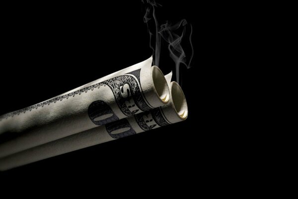 Smoke from twisted money on a black background